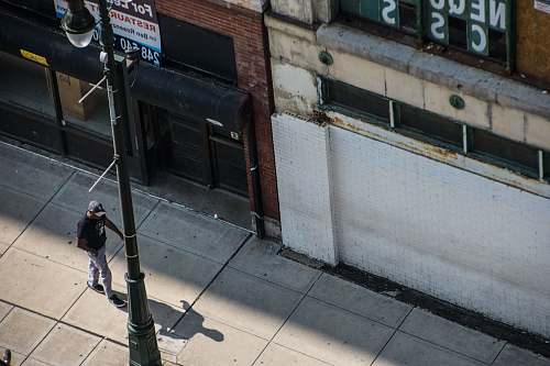 united states person walking on pedway beside utility pole grey